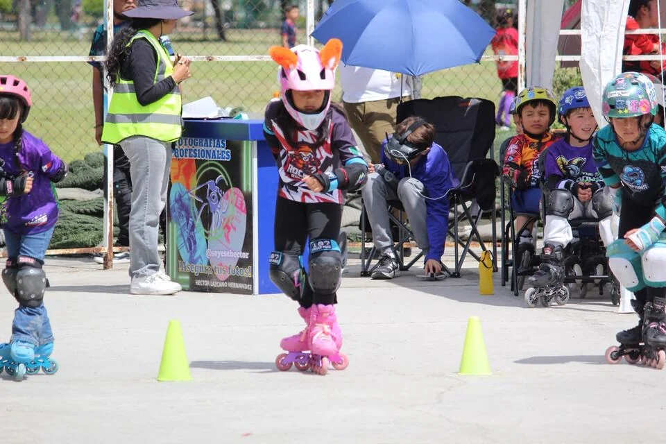 Una niña de Rocket Rollers recorre la zona de conos con casco y protecciones.